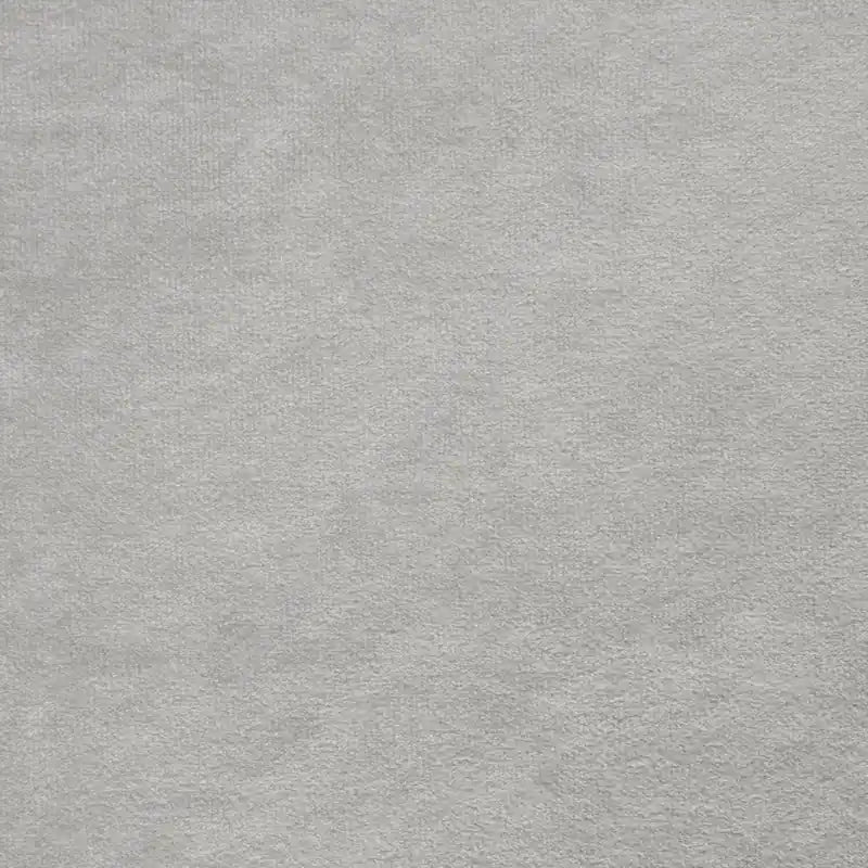 Lit capitonné à oreilles en velours gris avec des clous décoratifs et des boutons touffus
